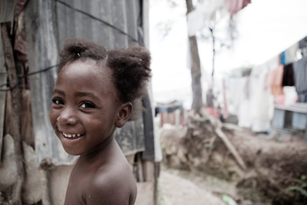 A young girl smiles in a tented camp in Port au Prince, Haiti