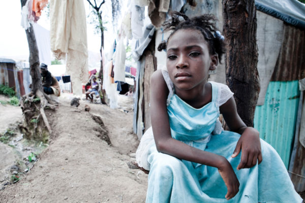 A girl sits in a tent city for those displaced by the January 2010 earthquake.